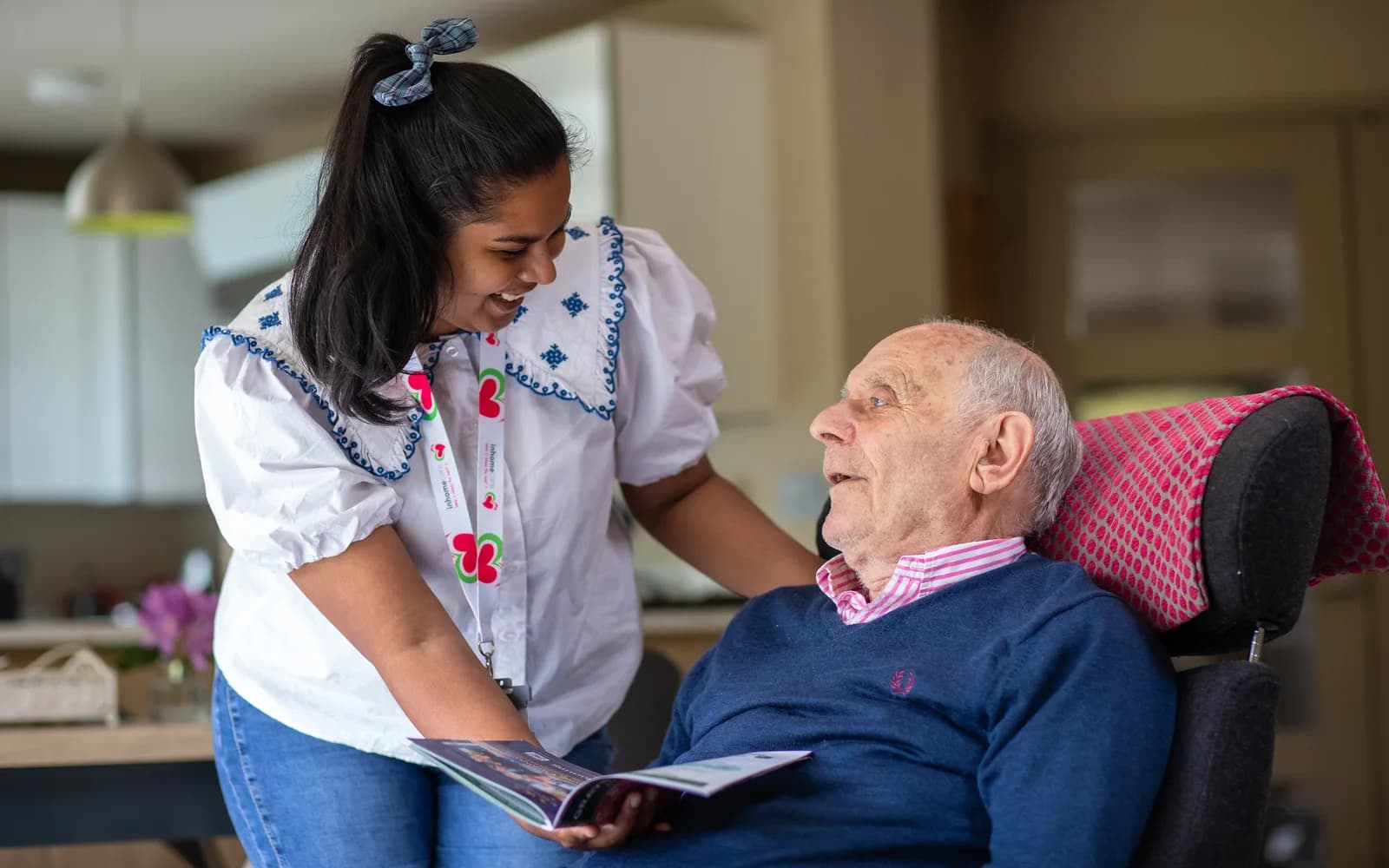 Carer and client reading flyer